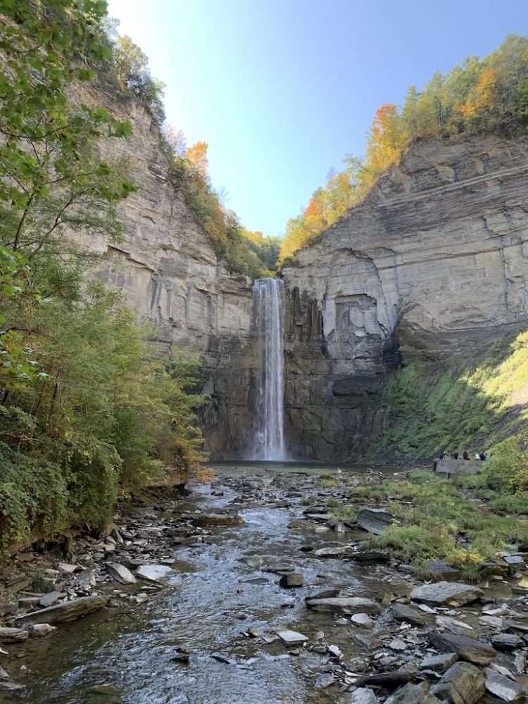 The beautiful Taughannock Falls in the Finger Lakes surrounded by autumn colors.